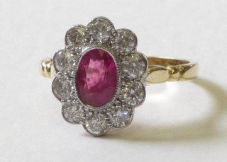 An 18ct yellow gold dress ring set an oval cut ruby surrounded by numerous diamonds, approx. 0.70/0.95