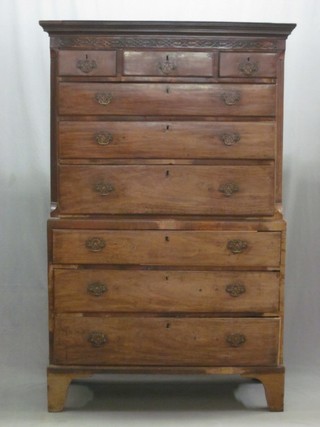 A Georgian III mahogany chest on chest, the upper section with moulded cornice and blind fret work frieze, fitted 3 short drawers and 3 long drawers, the base fitted 3 long drawers with brass plate drop handles, raised on bracket feet 44"