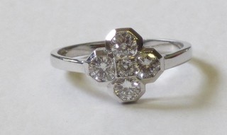 An 18ct white gold cross shaped ring set 5 diamonds, approx 0.75ct