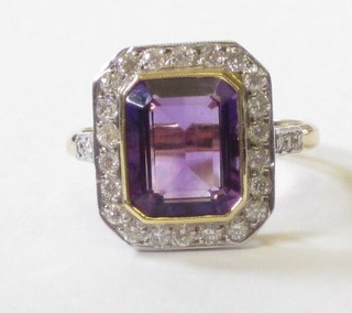 A lady's 18ct yellow gold dress ring set a rectangular cut amethyst supported by diamonds and with 6 diamonds to the shoulders approx 0.75ct