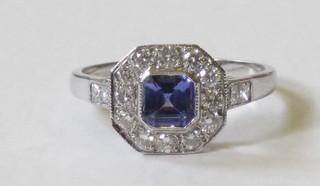 A lady's 18ct white gold dress ring set a square cut tanzanite supported by diamonds, approx 0.65/0.70ct