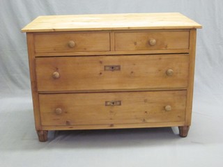 A Continental stripped and polished pine chest of 2 short and 2 long drawers with tore handles, raised on bun feet 41"