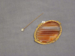 A Victorian oval agate brooch contained in a gilt metal mount together with a gold stick pin set a pearl 