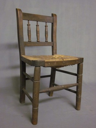 A 19th Century childs beech stick and rail back chair with woven rush seat