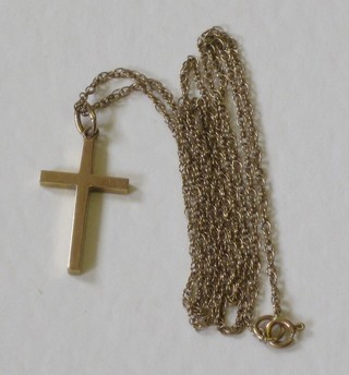A fine gold chain hung a gold Latin cross