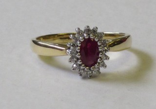 A lady's 18ct yellow gold dress ring set a ruby surrounded by diamonds