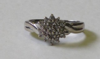 A lady's gold cluster ring set diamonds