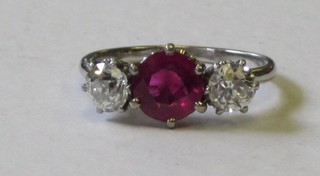 A lady's 18ct yellow gold dress ring set rubies supported by 2 diamonds, approx 1.20ct