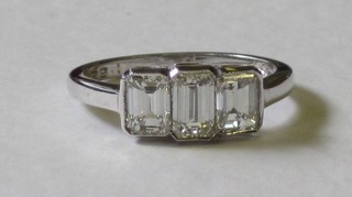 A lady's 18ct white gold dress/engagement ring set 3 emerald cut diamonds approx 1.55ct