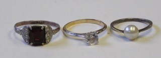 A lady's dress ring set a white stone and 2 other dress rings