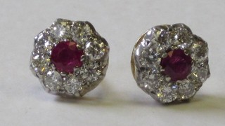 A pair of gold earrings set rubies, surrounded by diamonds, approx. 1.15ct