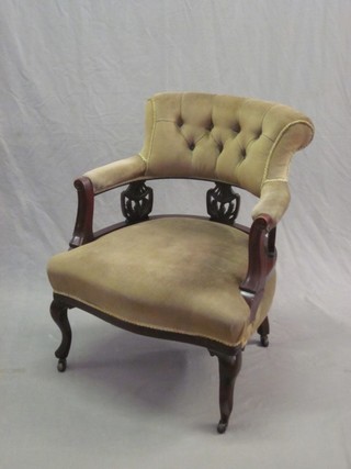An Edwardian mahogany tub back chair upholstered in green buttoned material, raised on cabriole supports