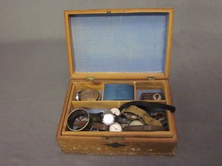 A rectangular box with hinged lid containing a collection of wristwatches