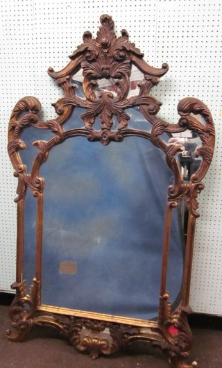 A plate mirror contained in a carved wooden Chippendale style frame 59"