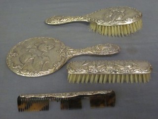 An Art Nouveau style 4 piece silver backed dressing table set decorated Angels comprising hair brush, hand mirror, clothes brush and comb