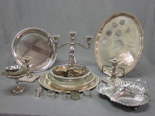 A silver plated twin light candelabrum, a pair of candlesticks, various silver plated trays, dishes etc