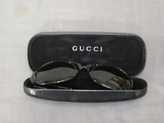 A pair of Gucci sunglasses, marked GG2400/M/S