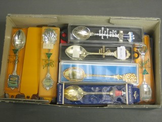 A collection of various souvenir teaspoons