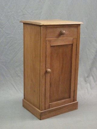 A 19th Century pine pedestal pot cupboard fitted a drawer, raised on a platform base