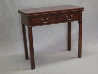 A 19th Century mahogany tea table, the base fitted 2 drawers raised on square supports 32"
