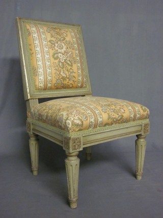 A grey painted French style nursing chair raised on turned and fluted supports