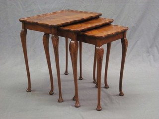 A nest of 3 Queen Anne style walnut interfitting coffee tables, raised on cabriole supports 19"