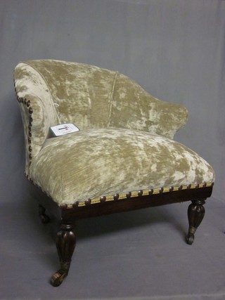A William IV rosewood framed tub back armchair upholstered in green material, raised on turned and reeded supports