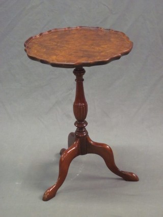 A circular walnut Queen Anne style wine table, raised on pillar and tripod supports 14"