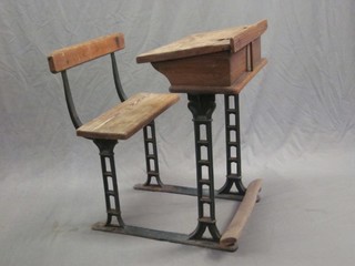 A childs elm and iron school desk