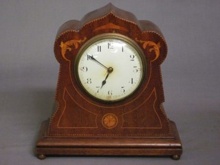 A French bedroom timepiece with enamelled dial and Arabic numerals contained in a shaped inlaid mahogany case