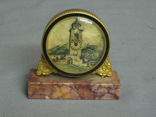 An 8 day travelling clock, the painted dial decorated a clock tower and contained in a gilt metal case, raised on a marble base