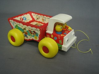 A wooden Fisher Price pull along toy in the form of a truck