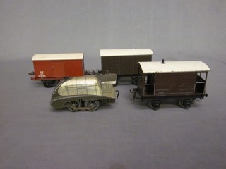 A Silver Link clockwork locomotive, a Hornby pressed metal rail truck, 1 other and a brake van