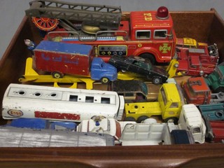 A pressed metal model of a fire engine and other toys cars