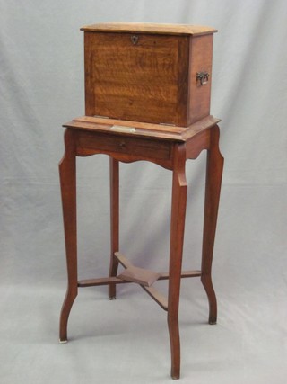 An Edwardian oak stationery box, raised on a rectangular table base with cabriole supports 16"