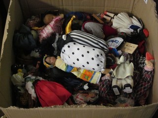 A box containing a large collection of various puppets, toy clowns etc