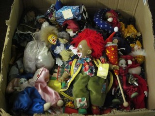A box containing a large collection of various puppets, toy clowns etc