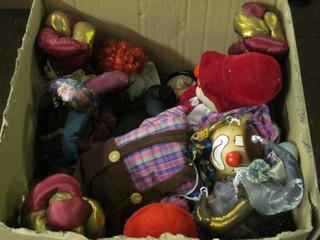A box containing a large collection of various puppets, clowns etc