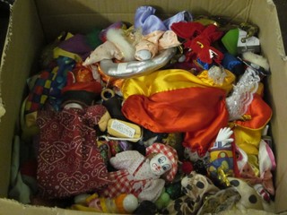 A box containing a large collection of various puppets, clowns etc