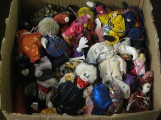 A box containing a large collection of various puppets, clowns etc