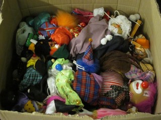 A box containing a large collection of various puppets etc