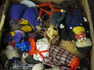 A box containing a large collection of various puppets etc