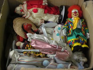 A box containing a large collection of various puppets etc