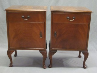 A pair of mahogany bedside cupboards fitted a drawer above cupboard, raised on cabriole supports 18"