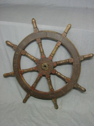 A reproduction circular 8 spoked wooden ships wheel 29"