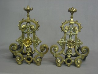 A pair of 19th Century pierced brass fire dogs