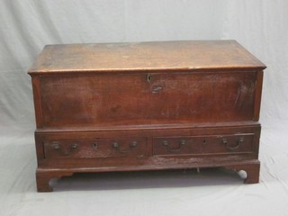 An 18th Century oak mule chest with hinged lid, the base fitted 2 long drawers, raised on bracket feet 44"