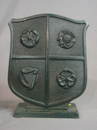 An iron fireside companion set stand in the form of a Heraldic coat of arms