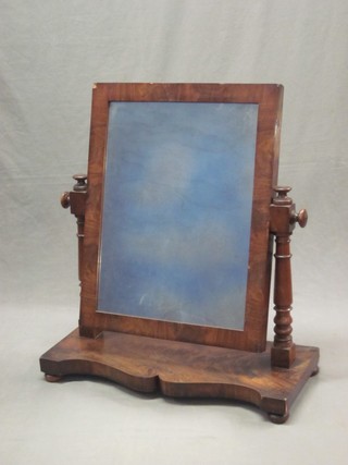 A Victorian rectangular plate dressing table mirror contained in a mahogany swing frame, raised on a shaped base 27"