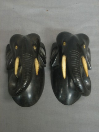A pair of carved ebony portrait busts of elephants 5"